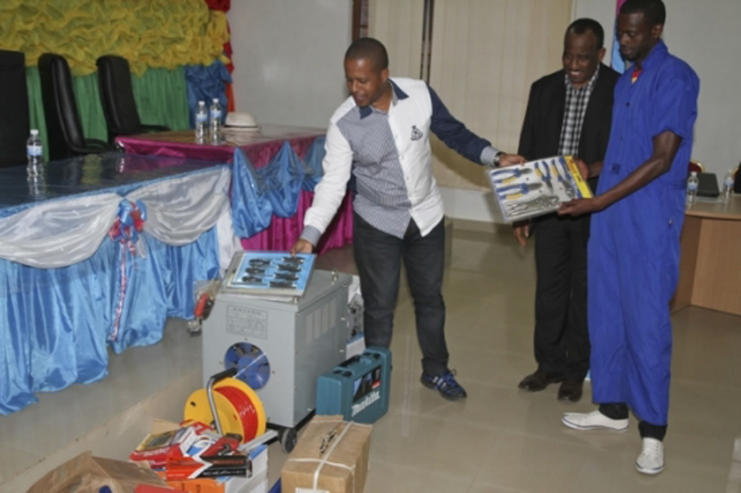 Director General of WDA Jerome Gasana handing over the start up kits to one of the trainees as the Assistant Director under ‘Belgian Common TVET Support Program’ (PAFP) ,Gideon Rudahunga looks on.